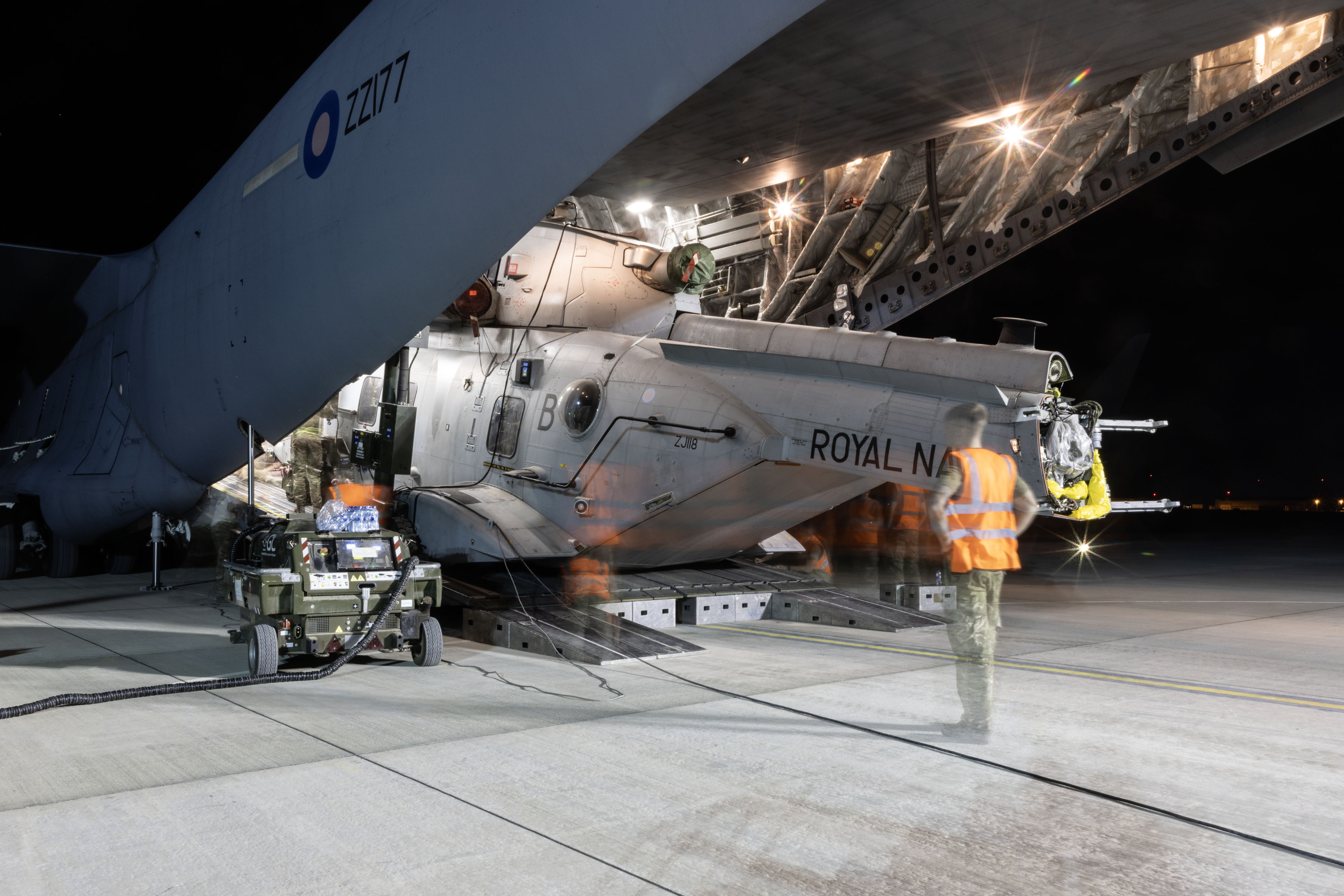 Photo - A view from outside the RAF Globemaster aircraft, of the Merlin on the ramp, being drawn inside the cargo bay